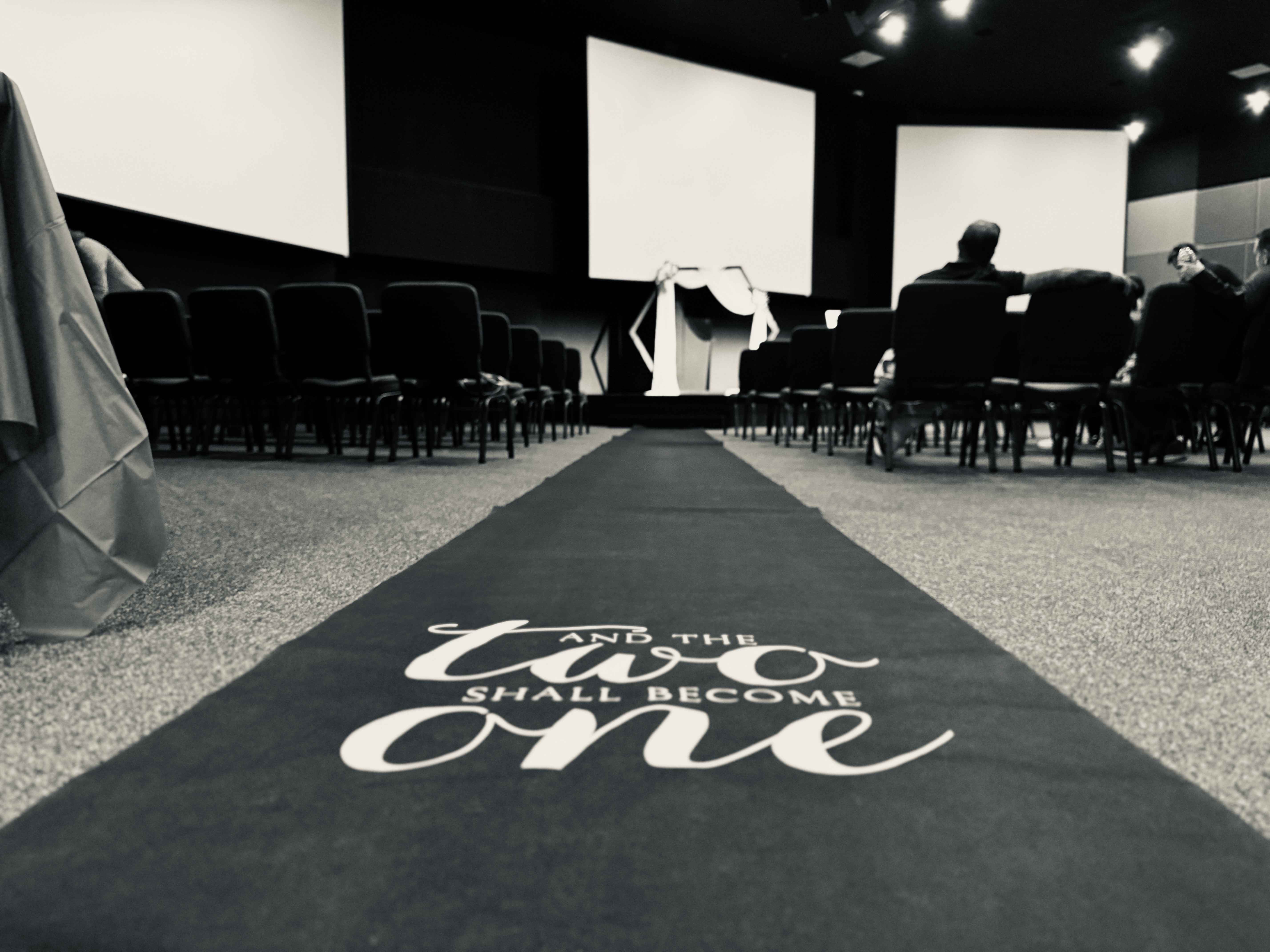 Wedding aisle with 'The Two Shall Become One' message